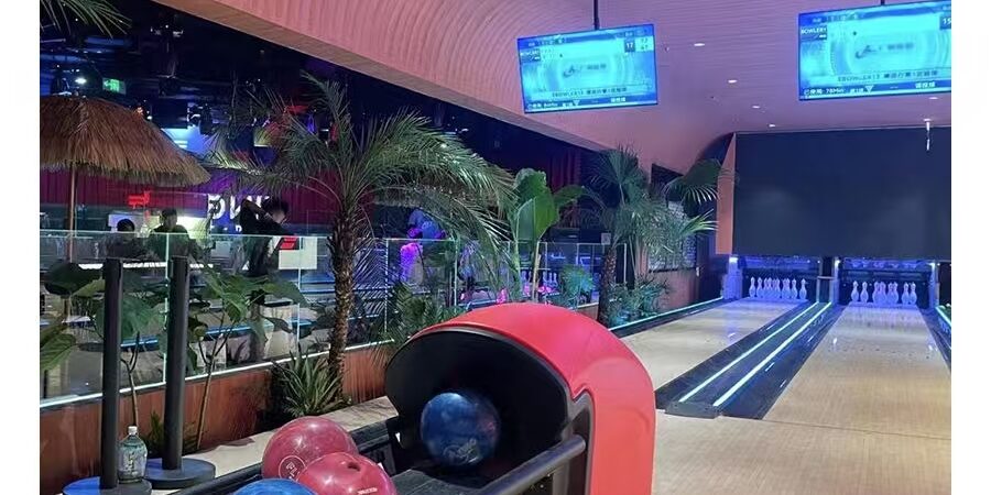 Bowling ball return for amusement bowling centers